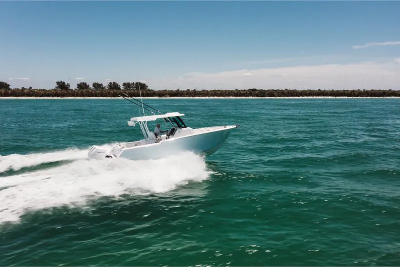 Slide: The Image of 2023 Bertram 28CC boat cruising on open water. - 15