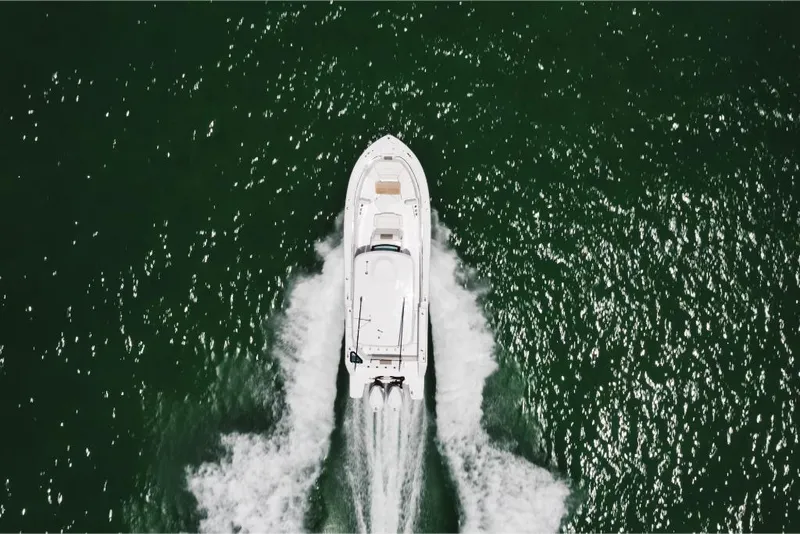 Slide: The Image of Aerial view of 2023 Bertram 28CC boat cruising on open water. - 17