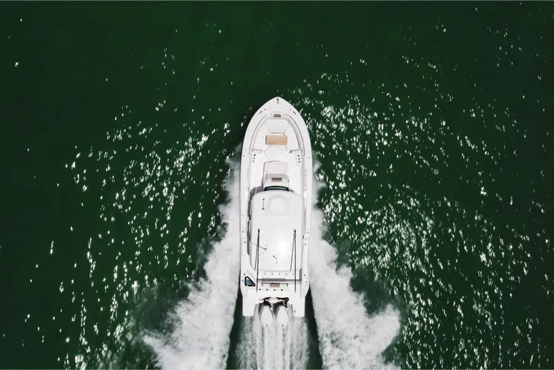 Slide: The Image of Aerial view of 2023 Bertram 28CC boat cruising on water. - 18