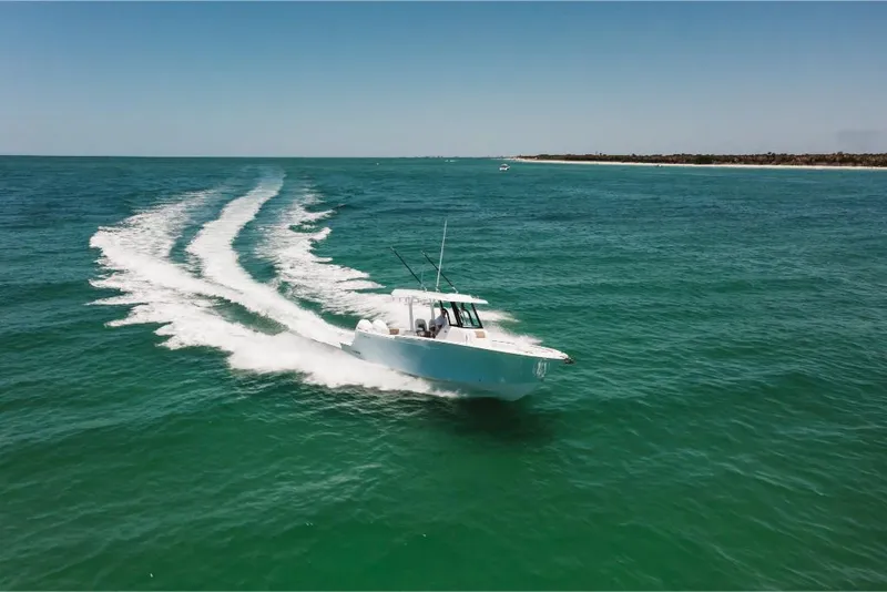 Slide: The Image of 2023 Bertram 28CC boat cruising on open water. - 20