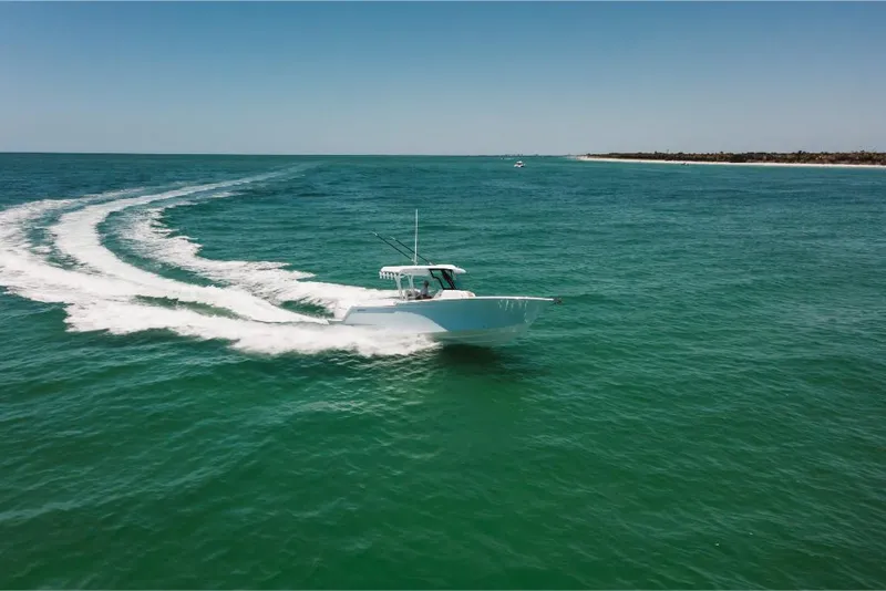 Slide: The Image of 2023 Bertram 28CC boat cruising on open water. - 21