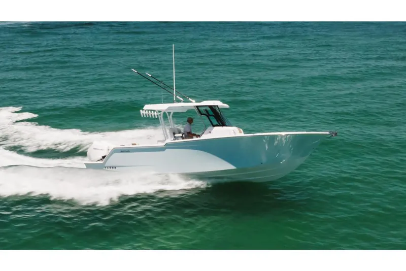 Slide: The Image of 2023 Bertram 28CC boat cruising on open water. - 22