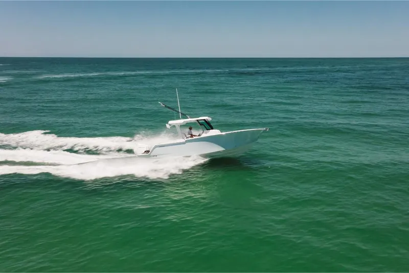 Slide: The Image of 2023 Bertram 28CC boat cruising on open water. - 24