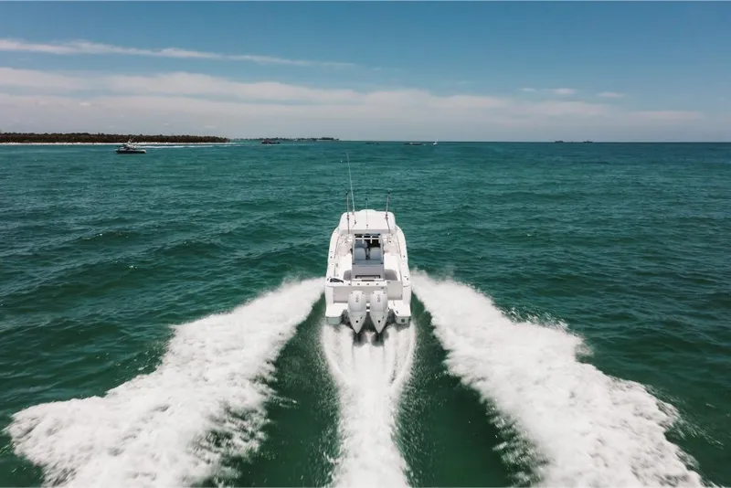Slide: The Image of 2023 Bertram 28CC boat cruising on open water. - 26