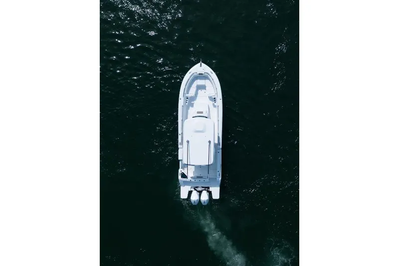 Slide: The Image of Aerial view of 2023 Bertram 28CC boat cruising on dark water. - 27