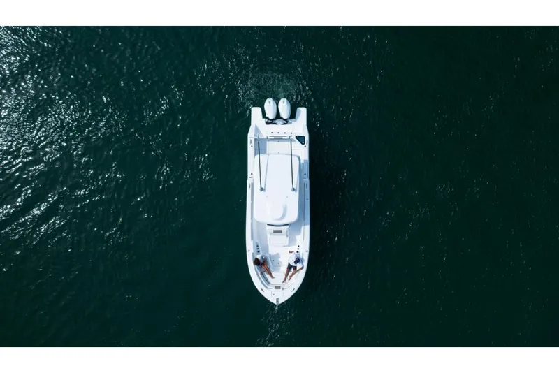 Slide: The Image of Aerial view of 2023 Bertram 28CC boat cruising on open water. - 28