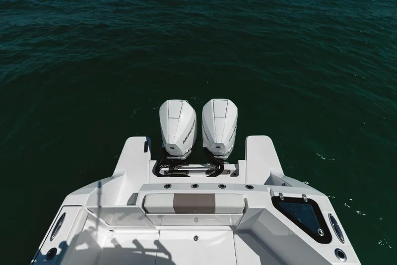 Slide: The Image of 2023 Bertram 28CC boat with twin outboard engines on the water. - 36
