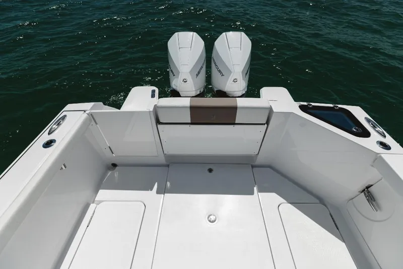Slide: The Image of 2023 Bertram 28CC boat with twin outboard engines on open water. - 39