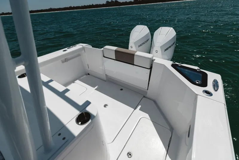 Slide: The Image of 2023 Bertram 28CC boat deck with twin Mercury engines on open water. - 40