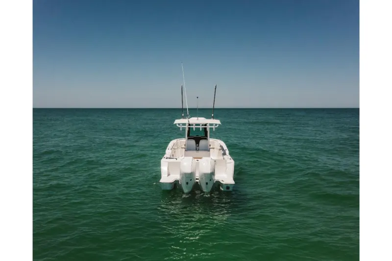 Slide: The Image of 2023 Bertram 28CC boat on open water, rear view. - 6