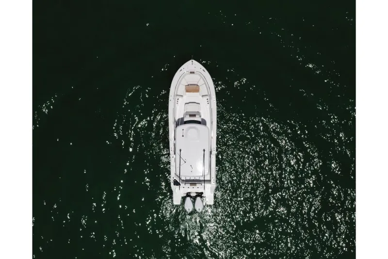 Slide: The Image of Aerial view of 2023 Bertram 28CC boat on dark green water. - 8