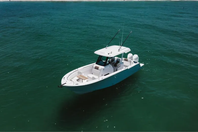 Slide: The Image of 2023 Bertram 28CC boat on open water. - 9