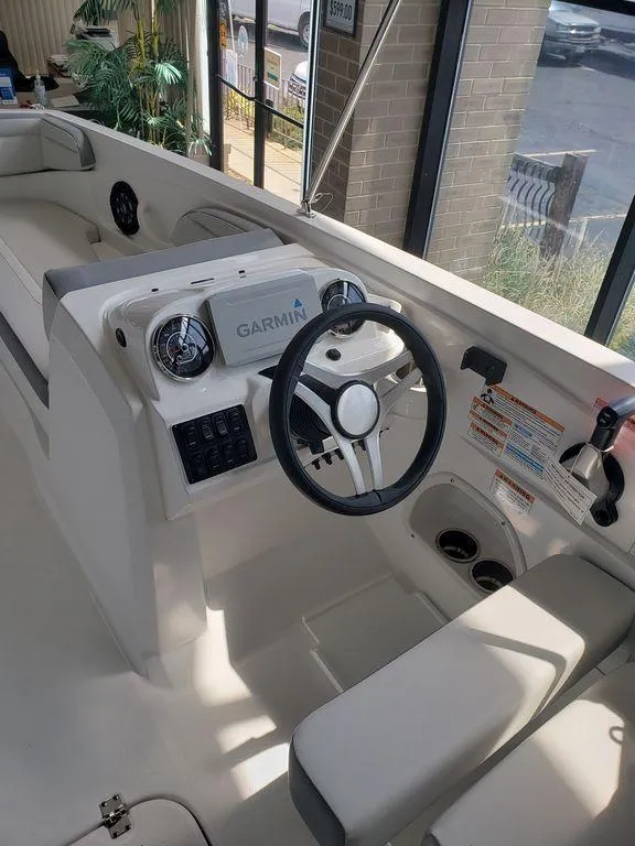 Slide: The Image of 2022 Hurricane SunDeck Sport 205 OB boat interior with Garmin navigation system. - 5