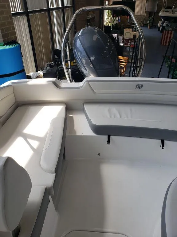 Slide: The Image of 2022 Hurricane SunDeck Sport 205 OB boat interior with seating and outboard motor. - 8