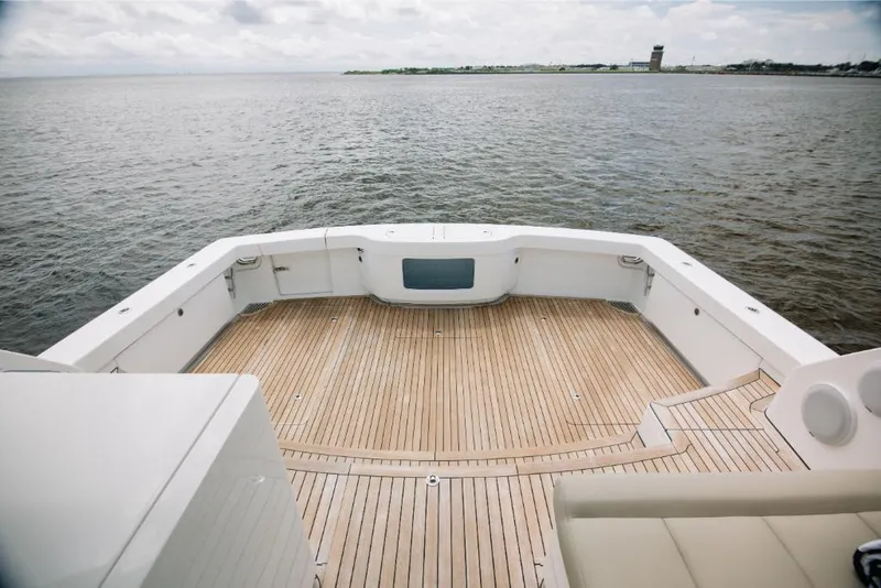 Slide: The Image of Bertram 50 Sport 2023 yacht with spacious teak deck overlooking calm waters. - 25