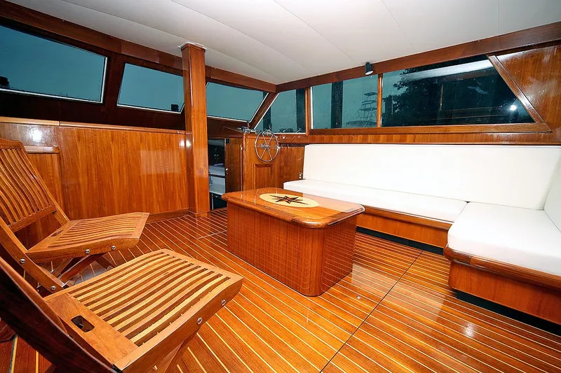 Slide: The Image of 1971 Hatteras 45 Convertible yacht interior with wooden furnishings and white seating. - 11