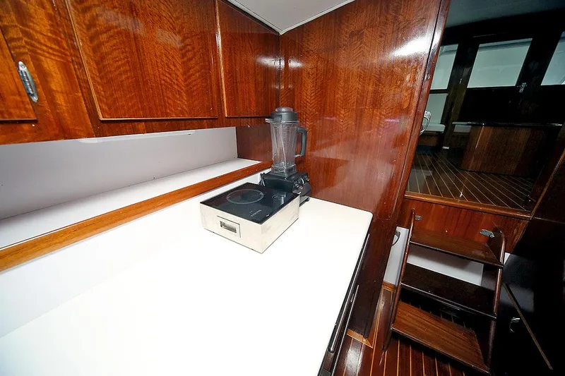 Slide: The Image of 1971 Hatteras 45 Convertible yacht kitchen with wooden cabinets and blender. - 20