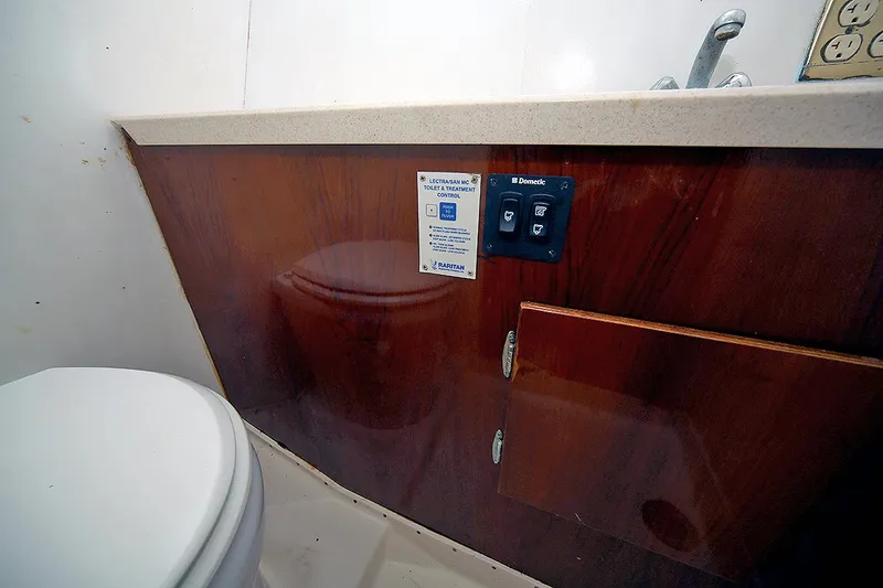 Slide: The Image of 1971 Hatteras 45 Convertible yacht bathroom with wooden cabinetry and toilet. - 26
