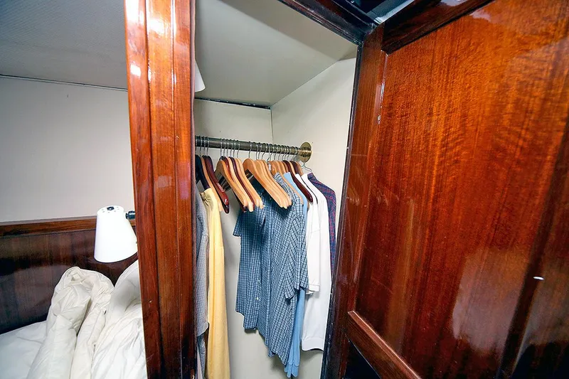Slide: The Image of Wooden closet interior on 1971 Hatteras 45 Convertible yacht with hanging clothes. - 31