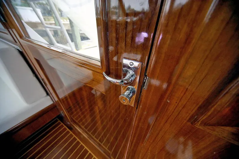 Slide: The Image of Polished wooden door with chrome handle on 1971 Hatteras 45 Convertible yacht. - 37