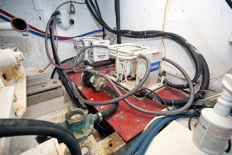 Slide: The Image of Engine room of a 1971 Hatteras 45 Convertible yacht with various equipment and wiring. - 42