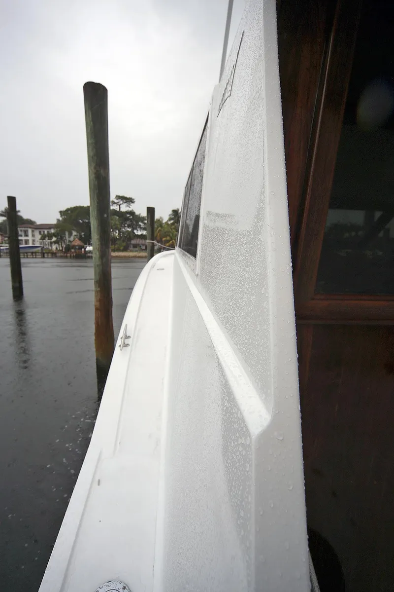 Slide: The Image of Side view of 1971 Hatteras 45 Convertible yacht in rainy weather. - 43