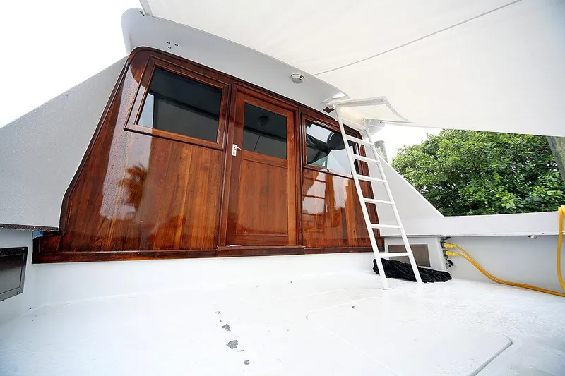 Slide: The Image of 1971 Hatteras 45 Convertible boat with wooden cabin doors and ladder. - 44