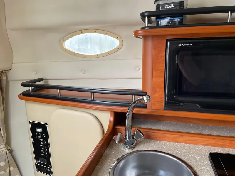 Slide: The Image of 2005 Rinker 250 Fiesta Vee cabin interior with sink and microwave. - 12
