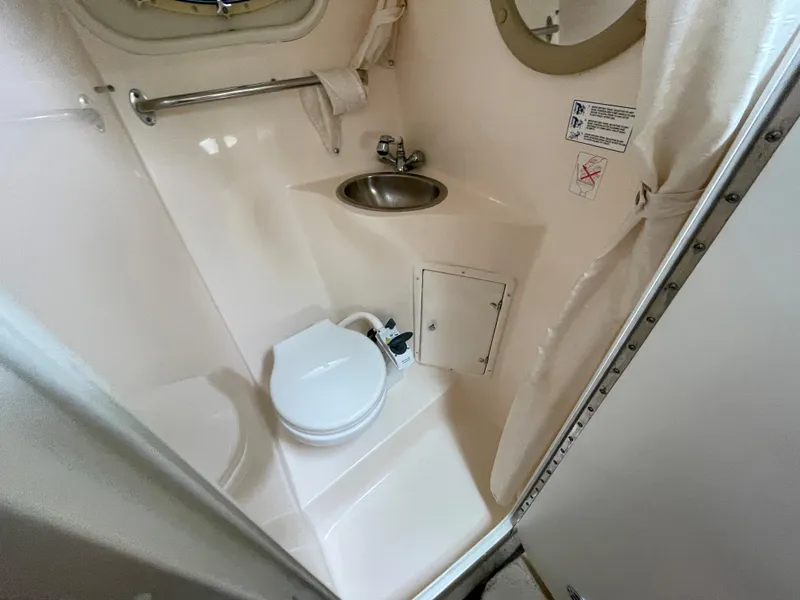 Slide: The Image of 2005 Rinker 250 Fiesta Vee boat bathroom with toilet, sink, and mirror. - 20
