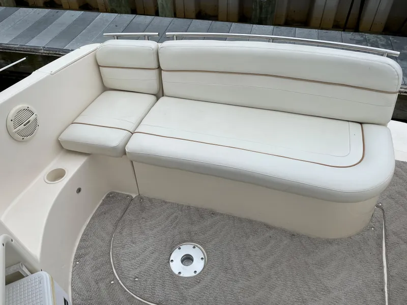 Slide: The Image of 2005 Rinker 250 Fiesta Vee boat interior with white cushioned seating. - 3