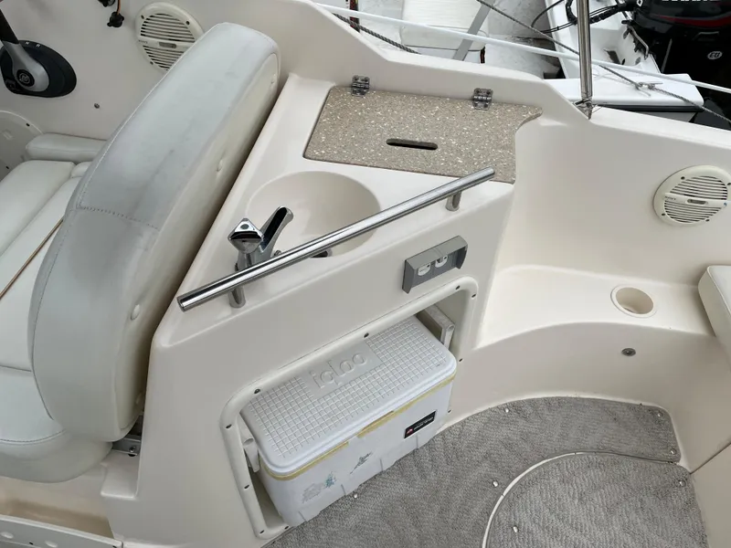 Slide: The Image of 2005 Rinker 250 Fiesta Vee boat interior with seating and storage compartment. - 4