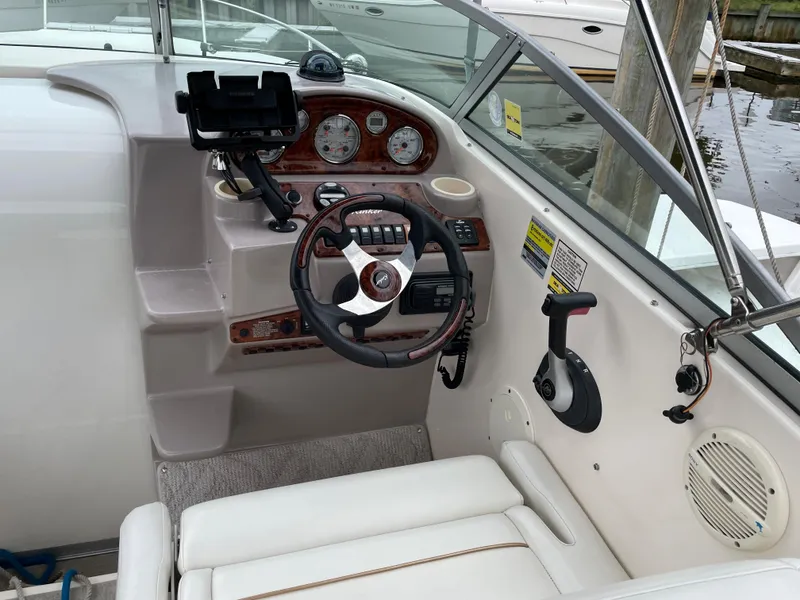 Slide: The Image of 2005 Rinker 250 Fiesta Vee boat cockpit with steering wheel and control panel. - 5