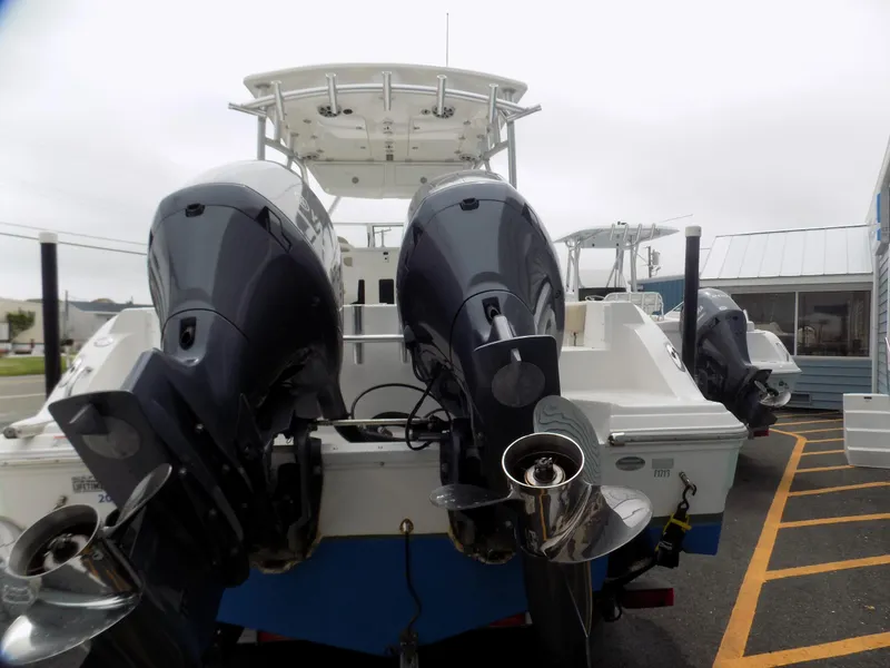 Slide: The Image of 2017 Sea Fox 256 Voyager boat with dual outboard motors, docked in a marina. - 3
