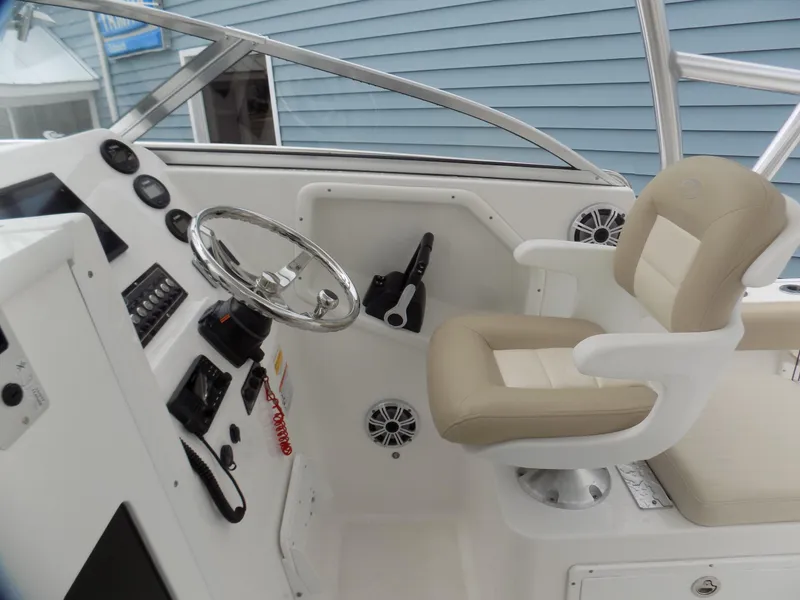 Slide: The Image of 2017 Sea Fox 256 Voyager helm with beige captain's chair and modern controls. - 8