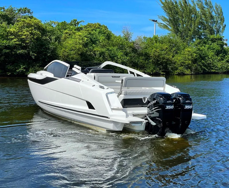 Slide: The Image of 2021 Fairline F Line 33 boat with twin Mercury 350 engines on a calm river. - 1