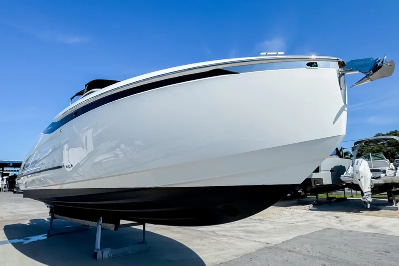 Slide: The Image of 2021 Fairline F Line 33 yacht on display under clear blue sky. - 11
