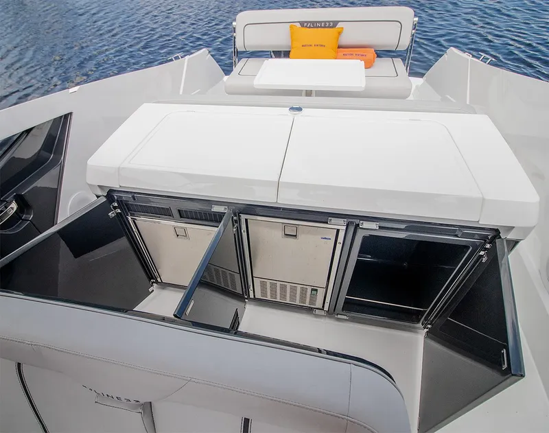 Slide: The Image of 2021 Fairline F Line 33 yacht with open storage compartments and seating area. - 18