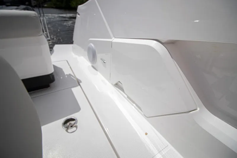Slide: The Image of 2021 Fairline F Line 33 yacht deck detail with white seating and storage compartments. - 22