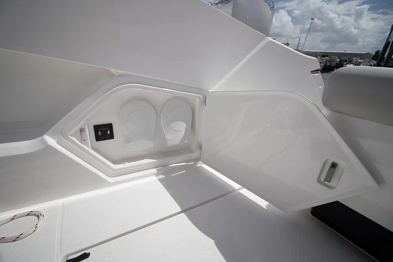Slide: The Image of Fairline F Line 33 2021 boat interior storage compartment with cup holders. - 26