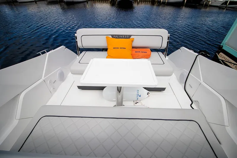 Slide: The Image of 2021 Fairline F Line 33 yacht seating area with table and cushions. - 29