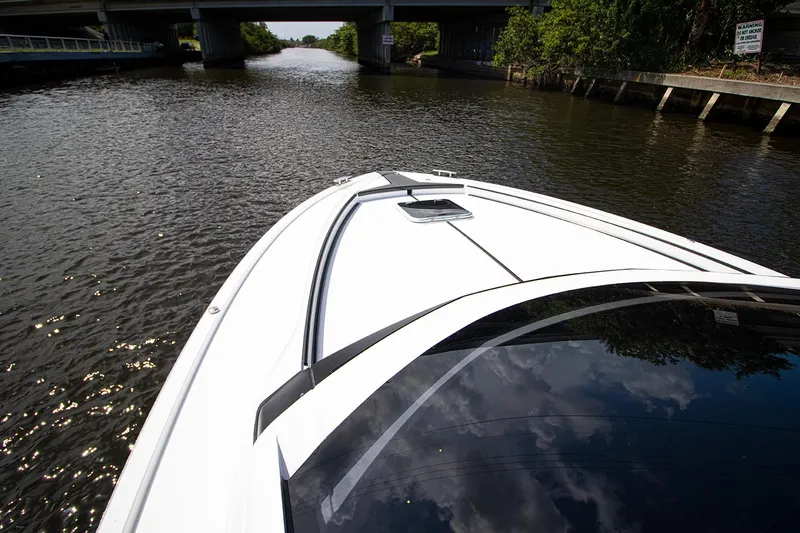 Slide: The Image of Fairline F Line 33 2021 yacht cruising on a river under a bridge. - 35