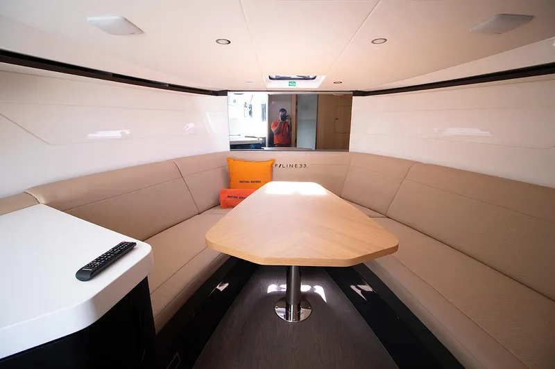 Slide: The Image of Interior of 2021 Fairline F Line 33 yacht with beige seating and wooden table. - 40