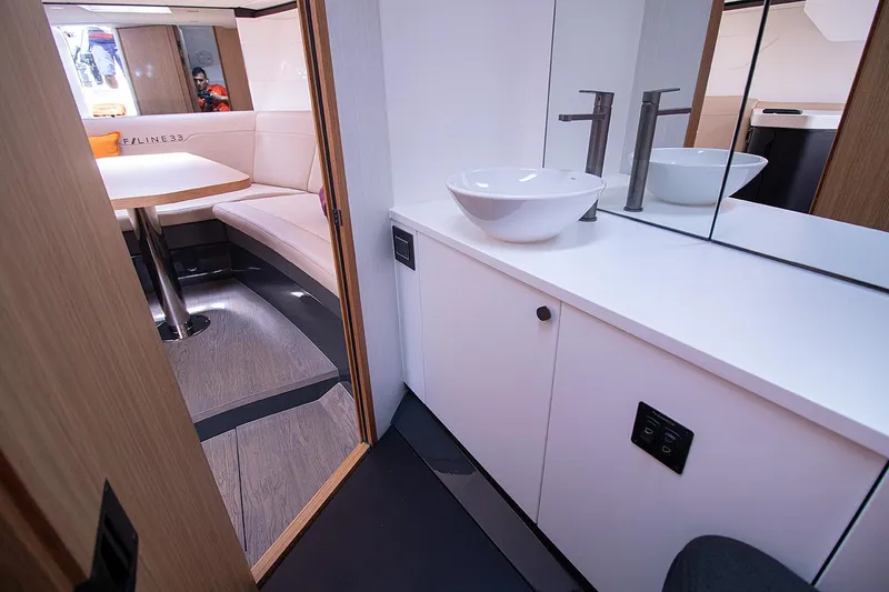 Slide: The Image of 2021 Fairline F Line 33 yacht interior with modern bathroom and seating area. - 45