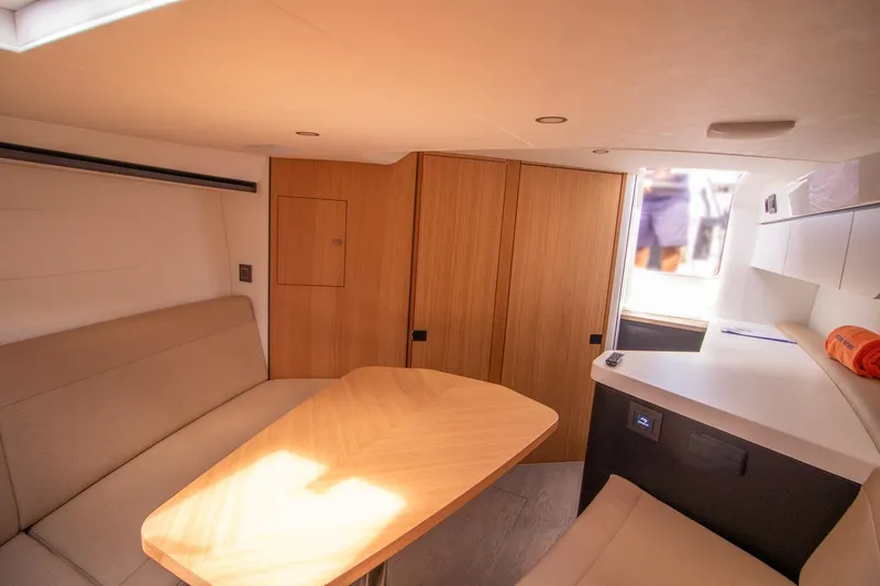 Slide: The Image of Interior of 2021 Fairline F Line 33 yacht with modern seating and wooden table. - 48