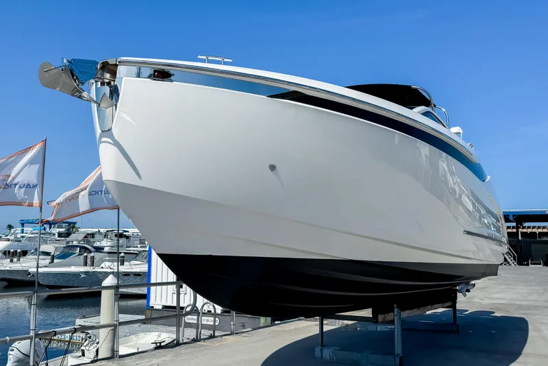 Slide: The Image of 2021 Fairline F Line 33 yacht displayed on a dock under clear blue skies. - 8