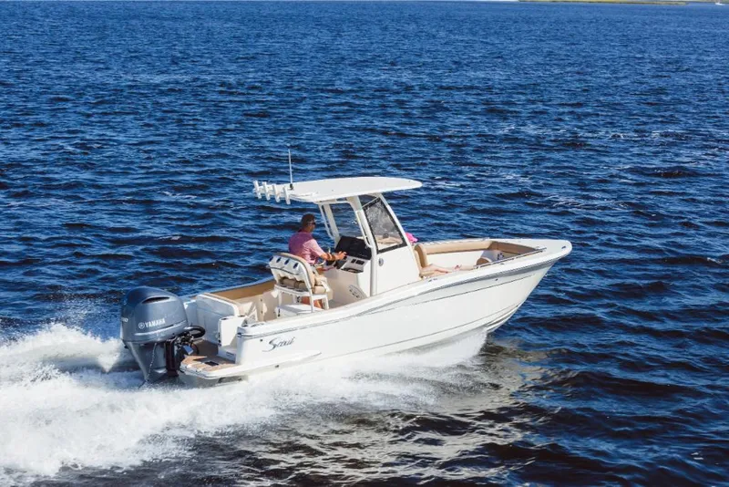Slide: The Image of 2023 Scout 240 XSF boat cruising on open water. - 0