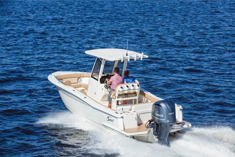 Slide: The Image of 2023 Scout 240 XSF boat cruising on open water. - 10