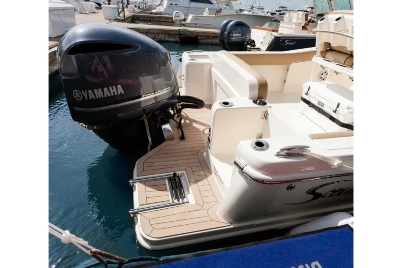 Slide: The Image of 2023 Scout 240 XSF boat with Yamaha outboard motor docked in marina. - 13