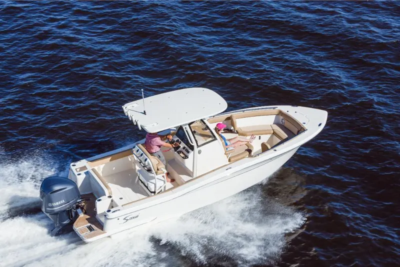 Slide: The Image of 2023 Scout 240 XSF boat cruising on open water. - 7