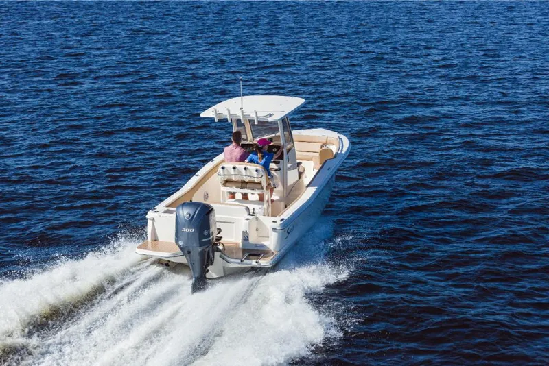 Slide: The Image of 2023 Scout 240 XSF boat cruising on open water. - 9